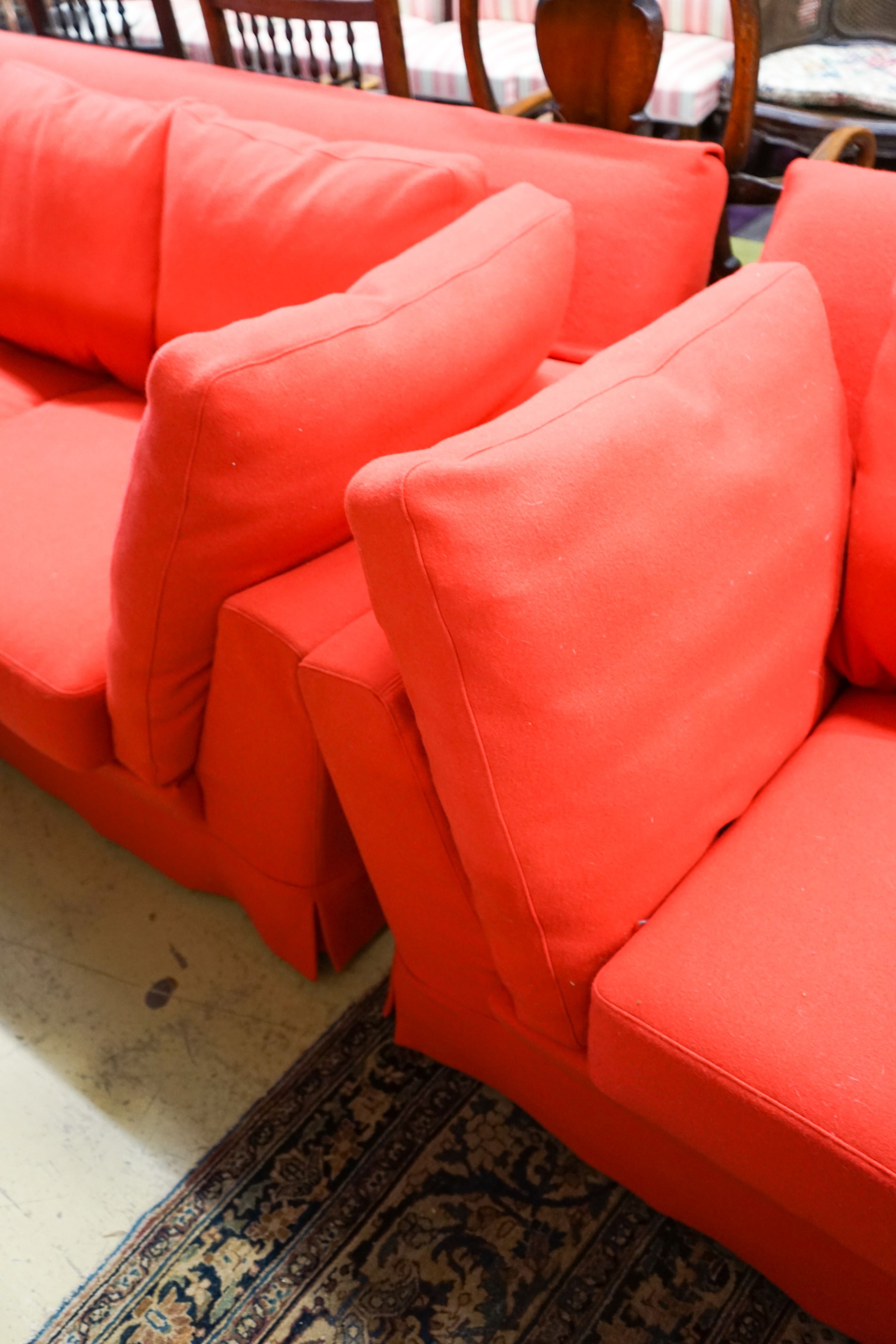 A contemporary Moroso three seater and two seater sofa upholstered in red fabric, the larger length 250cm, depth 100cm, height 79cm